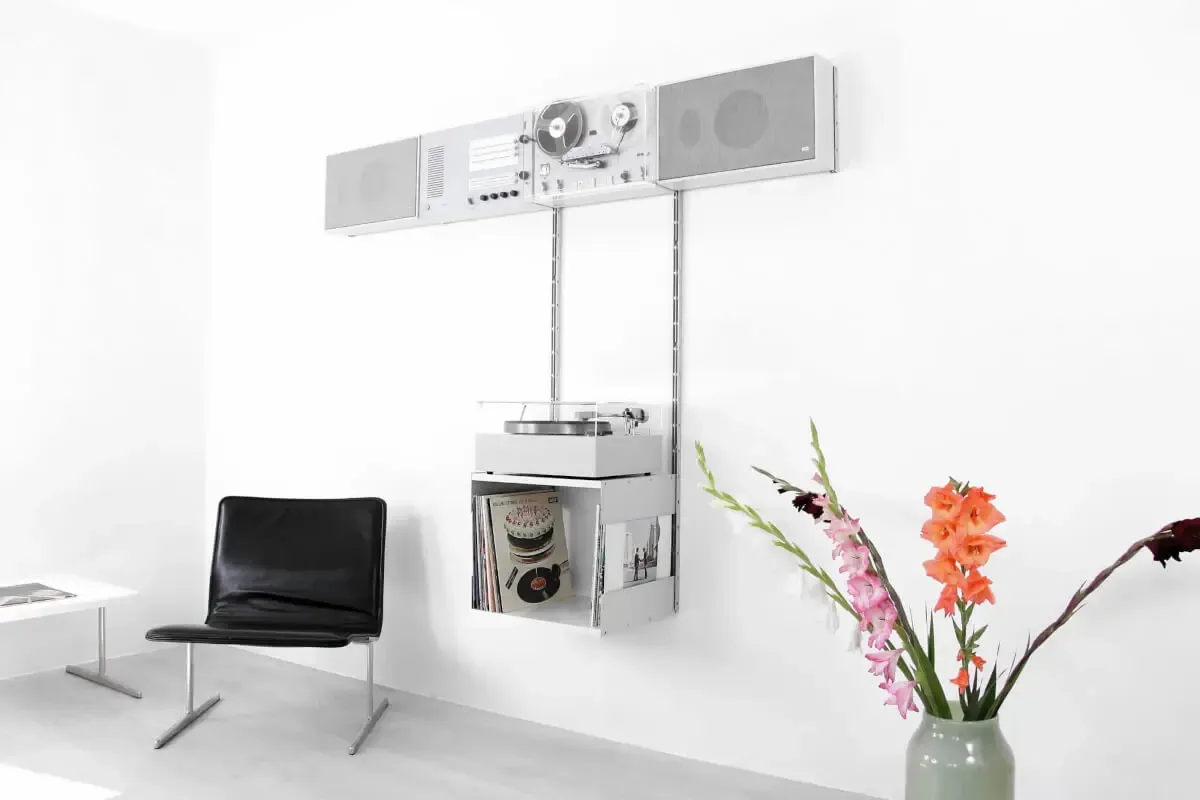 A Braun wall unit: separate grey audio modules hung in a row on two vertical rails, with a record player below.